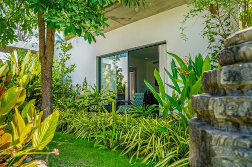 a garden view of a house with plants at The Villa by Metta in Siem Reap