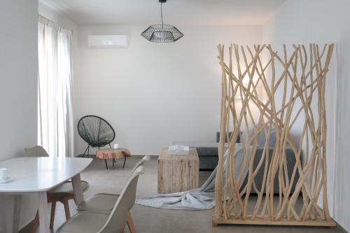 a living room with a table and a mirror at Sweet Home Naxos in Naxos Chora