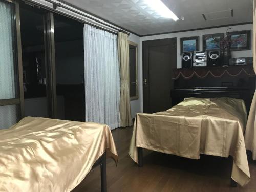 a bedroom with two beds and cameras on the wall at Takana in Nago