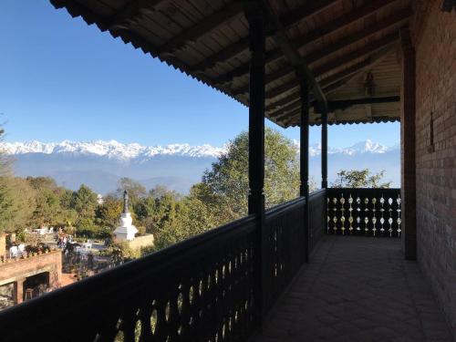 a balcony with a view of snow covered mountains at The Fort Resort in Nagarkot