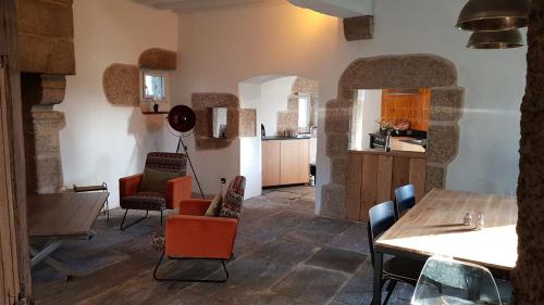 un salon avec une table et des chaises et une cuisine dans l'établissement Bocage Belle Histoire, à Moutiers-sous-Chantemerle