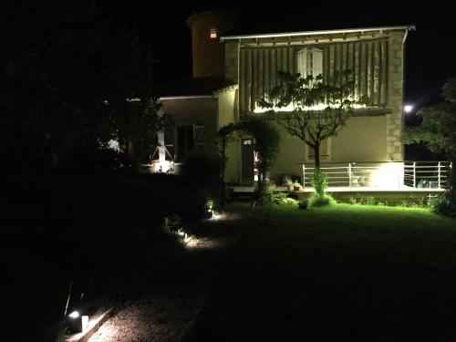 a house at night with lights in the yard at La Tour Barbacane in Alan