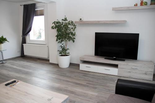 a living room with a large flat screen tv at Hotel Bannewitz B&B in Bannewitz
