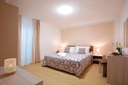 a hotel room with a bed and a large mirror at Residence Sala Comacina apartment no 2 with pool and spa by Italian Apartments in Isola Comacina