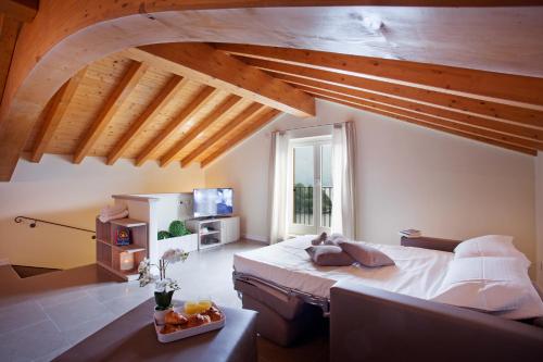 a bedroom with a large bed and a window at Residence Sala Comacina apartment no 2 with pool and spa by Italian Apartments in Isola Comacina