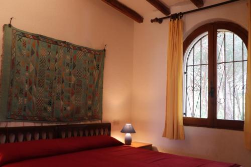 キアにあるChia Aloe & Cactusのベッドルーム1室(赤いベッド1台、窓付)