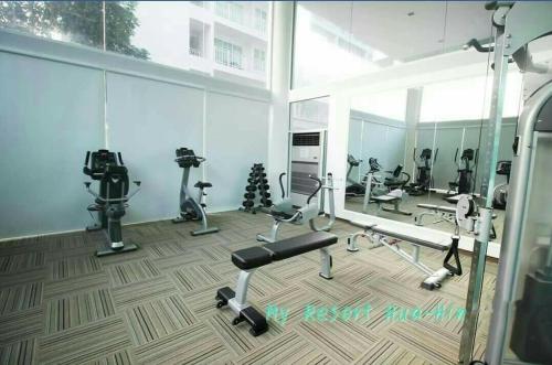 a gym with several exercise bikes and a mirror at My resort HuaHin By U home in Hua Hin