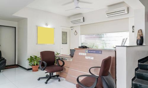 an office with two chairs and a desk and a counter at Treebo Brooks Manor in Pune