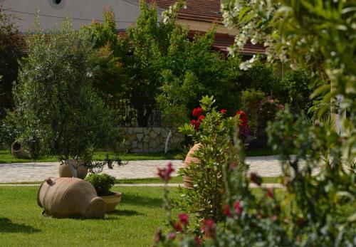 a garden with flowers and plants in a yard at Konstantina Apartments in Kavos