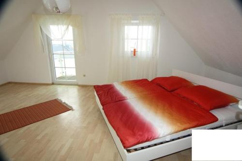 a bedroom with a large bed with red pillows at Obere Kellerstraße Haus 3 in Forchheim
