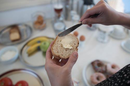 a person is holding a piece of food with a knife at Sweet Home Naxos in Naxos Chora