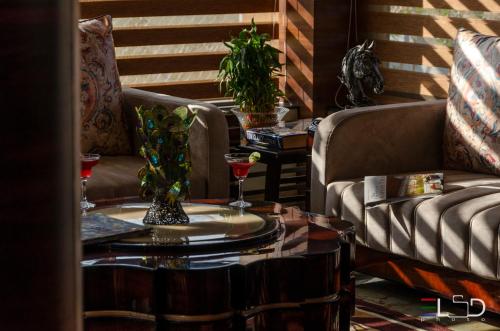 a living room with two couches and a table at Salcete Beach Resort in Colva