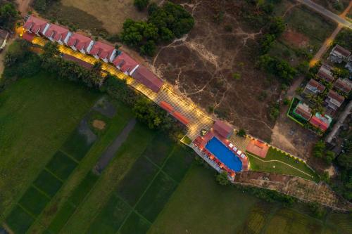 an overhead view of a bridge over a green field at Salcete Beach Resort in Colva