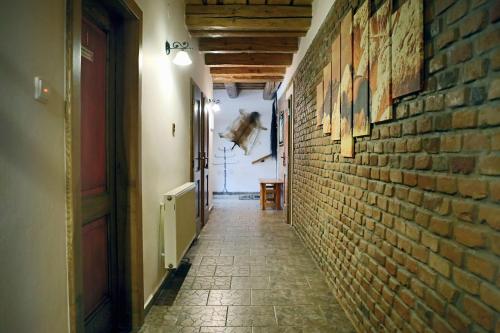 an empty hallway with a brick wall and a door at Steak Restaurant Penzion Country Saloon in Klatovy