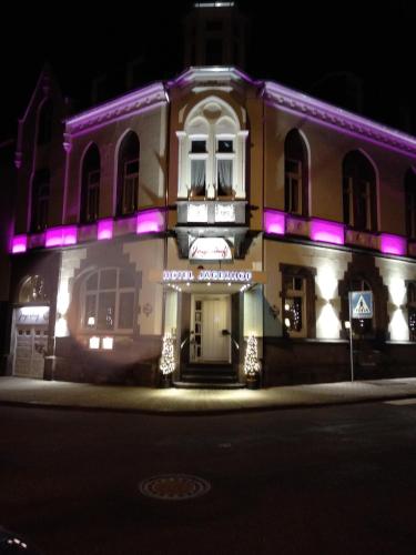 a building with purple lights on the front of it at Hotel Jägerhof in Mayen