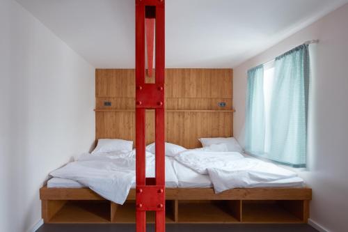 a bedroom with a bunk bed with white sheets at Pivovar Trautenberk in Horní Malá Úpa