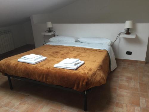 a bedroom with a bed with two towels on it at Mancini Michela Alloggio uso turistico in Acilia