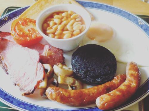 a plate of food with different types of food on it at Sunset House B&B in Penrith