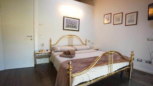 a bedroom with a bed and a table and pictures on the wall at R&B Il Melograno in Formigine