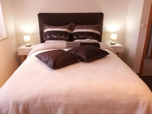 a bedroom with a large bed with two pillows at Welcome Guesthouse in Waimes