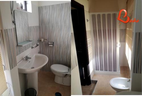 uma casa de banho com um WC branco e um lavatório. em Badia em Aversa