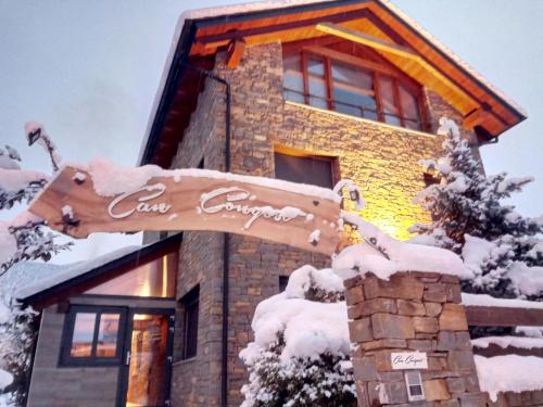a sign in front of a building covered in snow at Can Congost in Sort