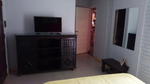 a bedroom with a dresser with a television on it at Posadas la hermosa in Posadas