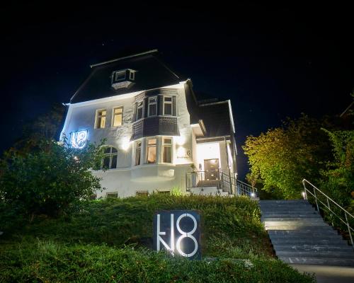 a house with a sign in front of it at night at LIONO BoutiqueHotel in Goslar