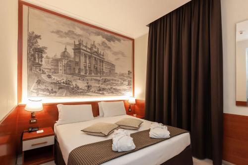 Ein Bett oder Betten in einem Zimmer der Unterkunft SHG Hotel Portamaggiore