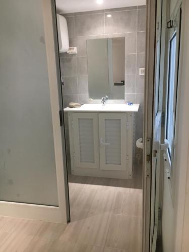 a bathroom with a white sink and a mirror at Le cocon de Sfax in Sfax