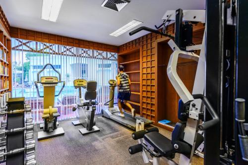 a fitness room with a gym with tread machines at Andaman Seaview, Karon Beach - SHA Plus in Karon Beach