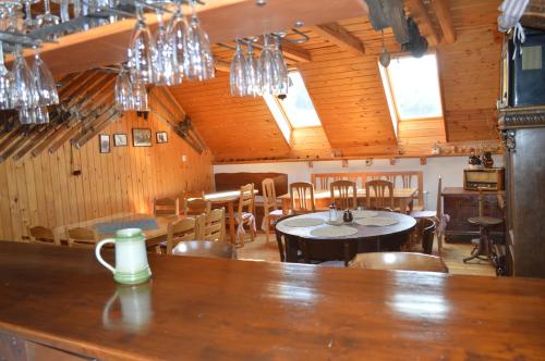 a dining room with tables and chairs and chandeliers at Penzion 409 in Horní Branná
