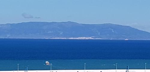 a large body of water with mountains in the background at Hotel Le Gardenia (ex Lutetia) in Tangier