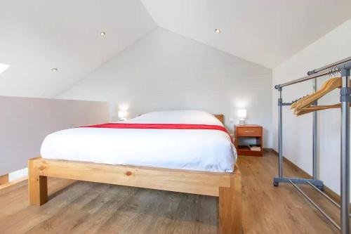 a bedroom with a bed and a bunk ladder at Domaine des Ecuries - Appartements meublés à Talloires in Talloires