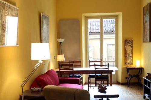 a living room with a couch and a table at La Casa Degli Angeli in Turin
