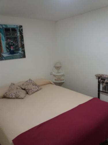 a white bed with two pillows on top of it at El Balcón de la Mata in Mata de Quintanar