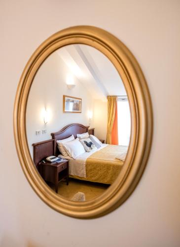 a bedroom with a bed in a mirror at Grand Hotel Italia in Orvieto