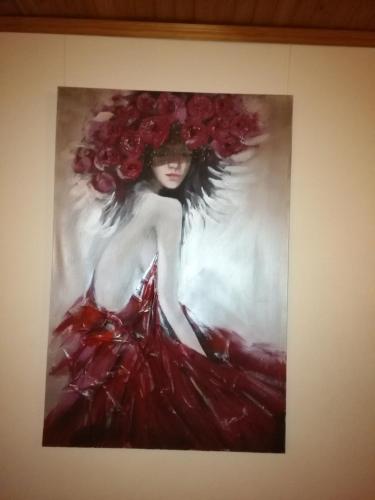 a painting of a woman in a red dress with flowers at Gratarre 2 in Kuressaare