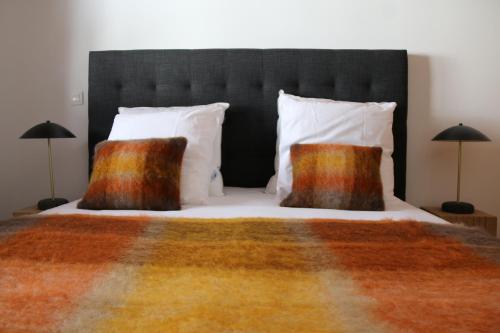 a bedroom with a large bed with two pillows at La Résidence de L'Ours in Megève