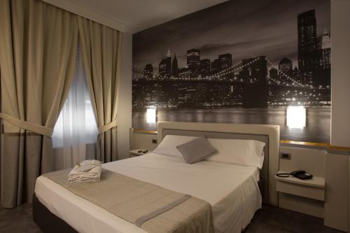Hotel City Legnano في لينيانو: غرفة نوم بسرير مع اطلالة على المدينة