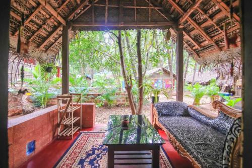 a living room with a couch and a table at Palm Trees Ayurvedic Heritage in Patnem