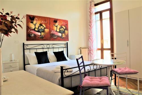 a bedroom with a bed and a table with chairs at Casa Bianca in Mestre