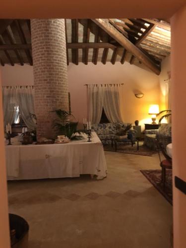 a living room with a table in the middle of a room at B&B Villa Valchero in Carpaneto Piacentino