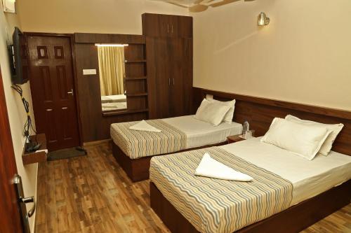 Ένα ή περισσότερα κρεβάτια σε δωμάτιο στο Velu's Resort