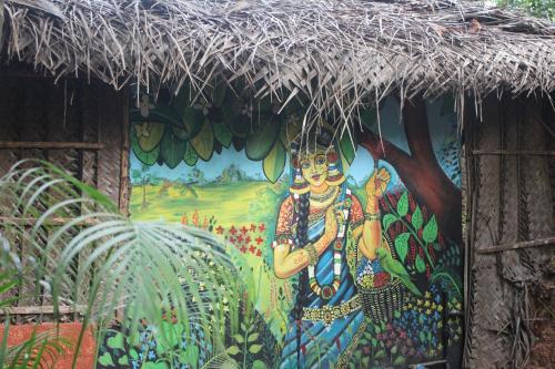 a painting of a woman on the side of a building at Palm Trees Ayurvedic Heritage in Patnem