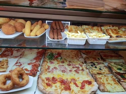 a display case with various types of pizzas and other foods at B&b I portici in Catanzaro