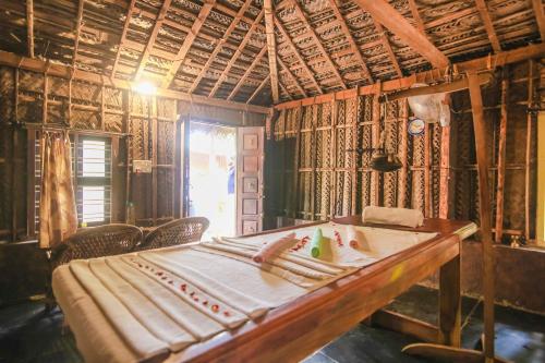 a room with a table with bananas on it at Palm Trees Ayurvedic Heritage in Patnem