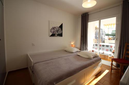 エンプリアブラバにあるBasic Comfort Apartment Pattaya 0158の窓付きの部屋にベッド付きのベッドルーム1室があります。