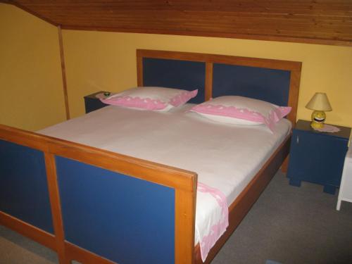 a bedroom with a bed with pink and white pillows at Villa Volga in Jelsa