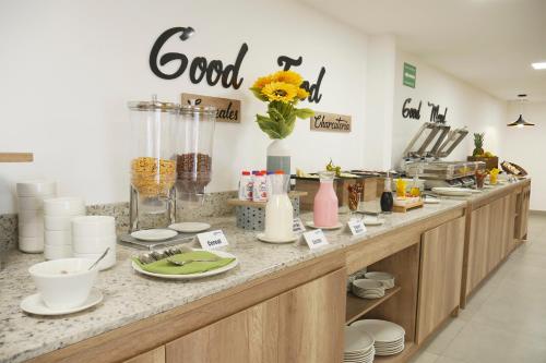a kitchen counter with a vase of flowers on it at Park Inn by Radisson Quito in Quito